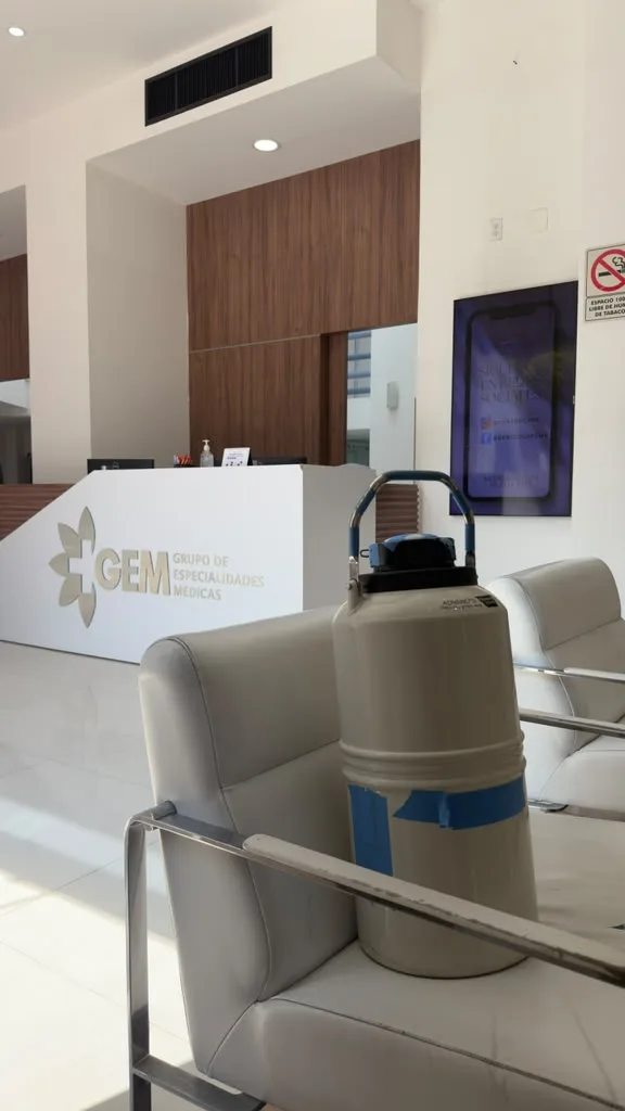 Cryogenic dry shipper at GEM specialized fertility clinic reception during US-Mexico cross-border transfer